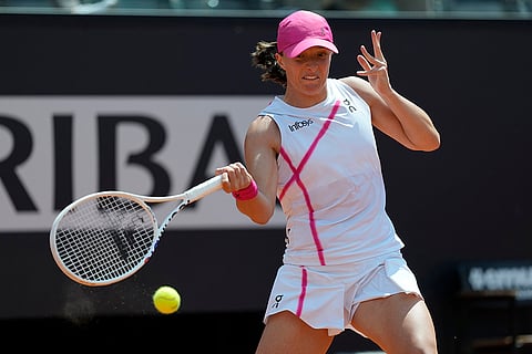 Iga Swiatek returns the ball to Madison Keys